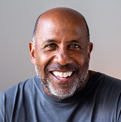 Senior man smiling in gray shirt
