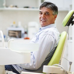 Man smiling while sitting in treatment chair