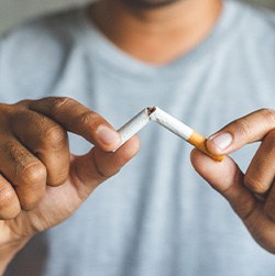 Closeup of patient breaking cigarette