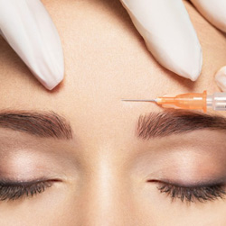 Close up of BOTOX being injected into patient’s forehead