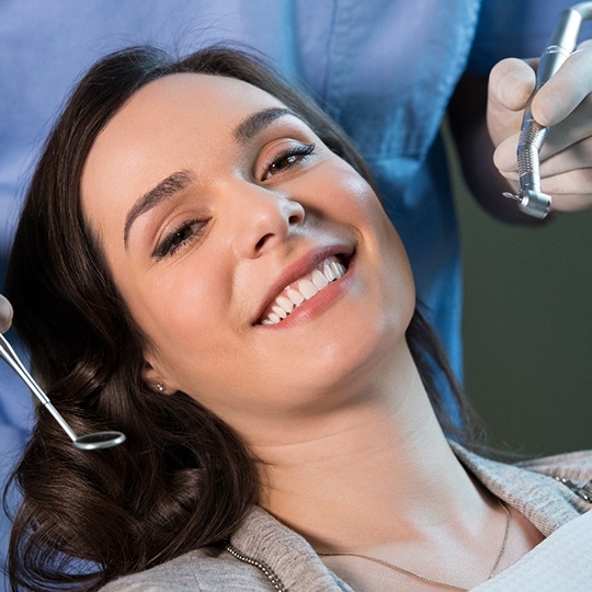 A smiling woman about to receive a dental checkup