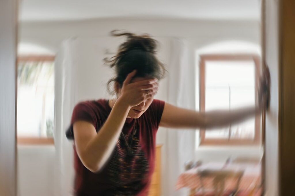 A woman experiencing a bout of dizziness