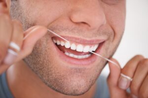 Man flossing his teeth